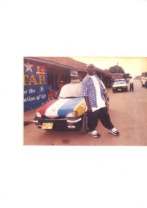 Mike 2 by a taxi he drove back in the day at Nkawkaw