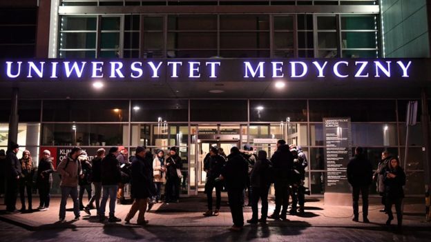 People gather at the entrance of the University Clinical Center, in which the wounded Mayor of Gdansk Pawel Adamowicz is being treated