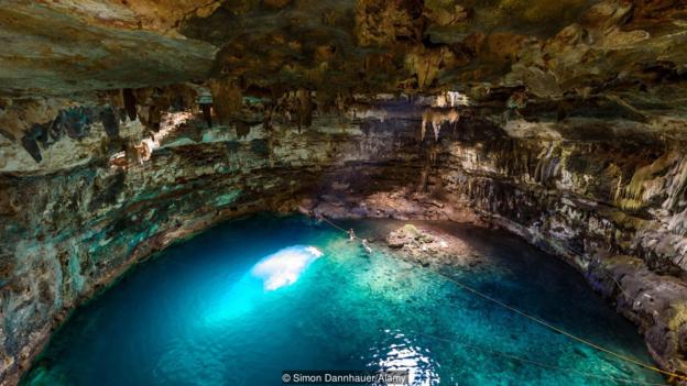 Mexico’s Yucatan Peninsula is famous for its cenotes, blue water sinkholes that dot the arid landscape (Credit: Credit: Simon Dannhauer/Alamy)