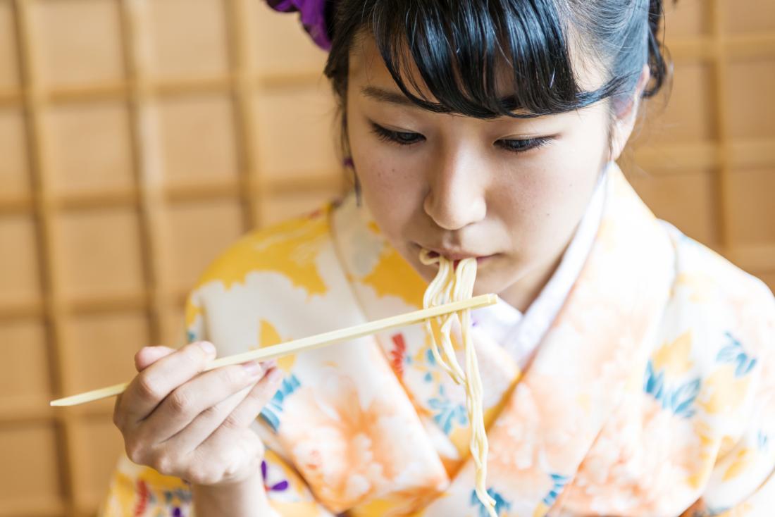 woman in kimono eating noodles