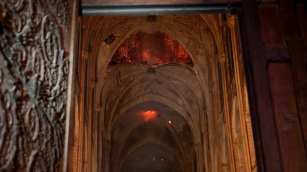 Flames and smoke rise from the interior of Notre-Dame Cathedral in Paris on April 15, 2019