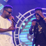 Sarkodie (white) and Shatta Wale perform together at a show