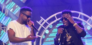 Sarkodie (white) and Shatta Wale perform together at a show