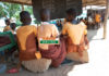 students sit on block