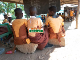 students sit on block