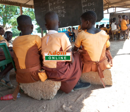 students sit on block