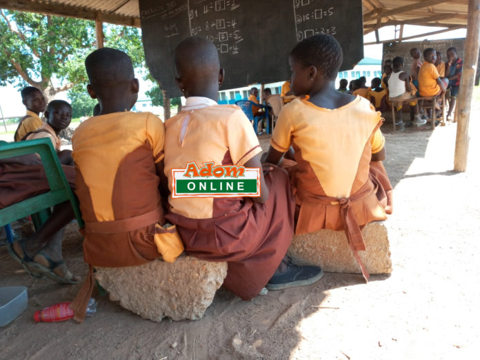 students sit on block