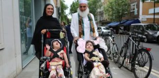 Safa and Marwa Ullah leave hospital with their mother and their grandfather. Photograph: Great Ormond Street Hospital/PA