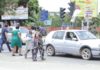 Pedestrains crossing the road in front of the 37 Military Hospital in Accra