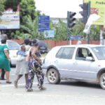 Pedestrains crossing the road in front of the 37 Military Hospital in Accra