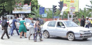 Pedestrains crossing the road in front of the 37 Military Hospital in Accra