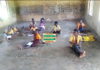 classroom pupils sit on bare floor