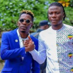 Shatta Wale (L) and Stonebwoy smoke the peace pipe