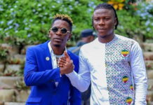 Shatta Wale (L) and Stonebwoy smoke the peace pipe