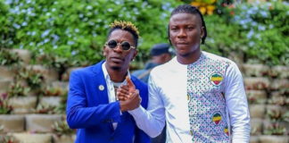 Shatta Wale (L) and Stonebwoy smoke the peace pipe