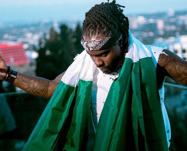 Wale wearing a Nigerian flag around his neck/ Photo credit: Instagram: @Wale