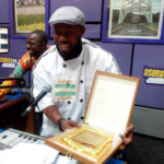 Enoch Kwesi Worlanyo displaying his award