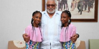 The twins in a photograph with former President John Rawlings