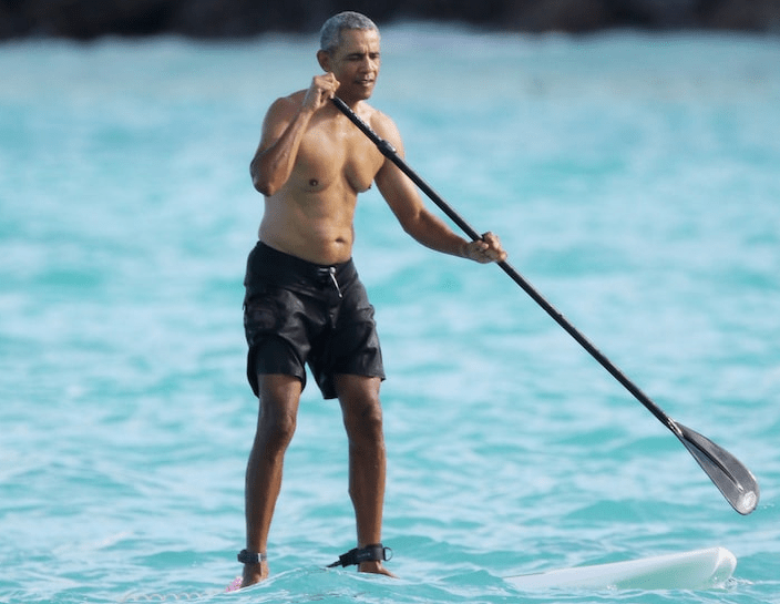 Photo: Obama pictured paddleboarding in Hawaii Photo: Obama pictured paddleboarding in Hawaii