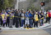 People gather on Las Virgenes Road in Calabasas near the scene of Sunday’s helicopter crash.(Mel Melcon / Los Angeles Times)