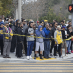 People gather on Las Virgenes Road in Calabasas near the scene of Sunday’s helicopter crash.(Mel Melcon / Los Angeles Times)