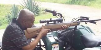 South Africa's Jacob Zuma takes aim in rifle photo
