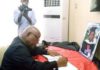 The Speaker, Reverend Professor Mike Oquaye signing the book of condolence