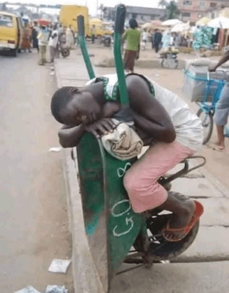 Man sleeping on a wheelbarrow