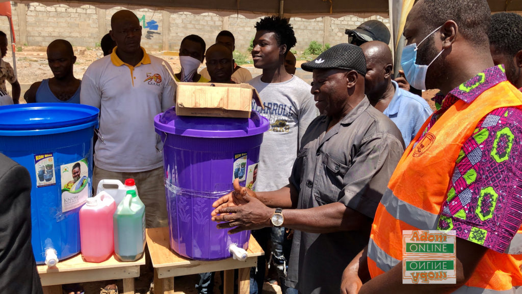 Mr Abubakar Seibu, the station master at Shiashie demonstrates hand-washing with soap under running water