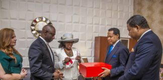 Pastor Chris Oyakhilome accepting gift from Wife (middle) of late Bishop Benson Idahosa