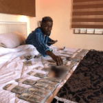 Shatta Wale shows off his money in bed