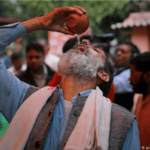 A group of Indians holding a cow urine drinking party