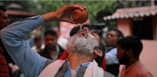 A group of Indians holding a cow urine drinking party