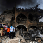 Paramedics and security men observe a building that was damaged by the pipeline explosion at Abule Ado in Lagos, Nigeria, March 15, 2020. (Reuters Photo)