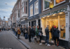 A queue of people line up outside a shop called Doctor Green - one of Holland's famous 'coffee shops' - in the Hague yesterday after the Dutch government announced that many businesses were closing over coronavirus fears