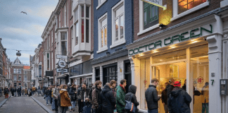 A queue of people line up outside a shop called Doctor Green - one of Holland's famous 'coffee shops' - in the Hague yesterday after the Dutch government announced that many businesses were closing over coronavirus fears