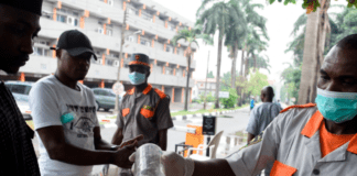 A security guard administering sanitizer to a hospital visitor in Lagos, Nigeria, on Friday.Credit...Pius Utomi Ekpei/Agence France-Presse — Getty Images