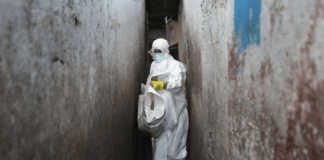 PHOTO: A Red Cross burial team wore protective clothing to visit houses where people were infected with Ebola. (Getty Images: John Moore)