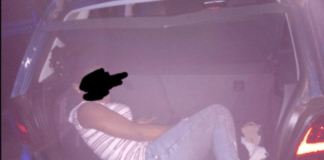 Man arrested for attempting to smuggle his girlfriend in his car booth