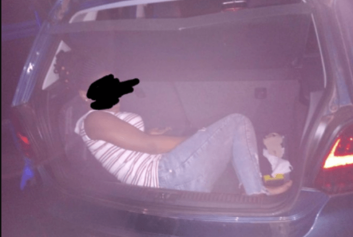 Man arrested for attempting to smuggle his girlfriend in his car booth