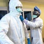 Health Workers putting on Personal Protective Equipment (PPE)