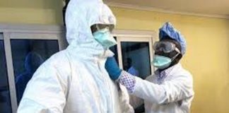 Health Workers putting on Personal Protective Equipment (PPE)