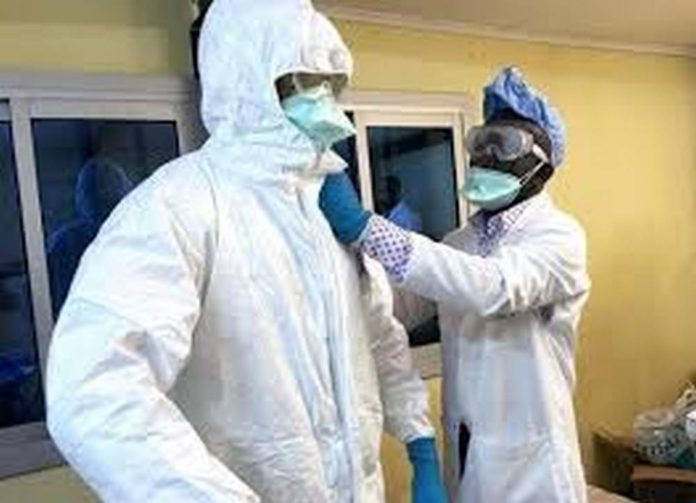 Health Workers putting on Personal Protective Equipment (PPE)