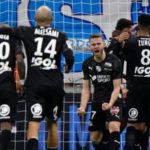 Amiens players celebrate scoring a goal against Marseille