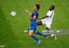 HANOVER, GERMANY - JUNE 12: Samuel Kuffour of Ghana thwarts the progress of Alberto Gilardino of Italy during the FIFA World Cup Germany 2006 Group E match between Italy and Ghana played at the Stadium Hanover on June 12, 2006 in Hanover, Germany. (Photo by Shaun Botterill/Getty Images)
