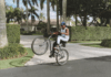 Abraham Attah riding his bicycle skillfully