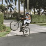 Abraham Attah riding his bicycle skillfully