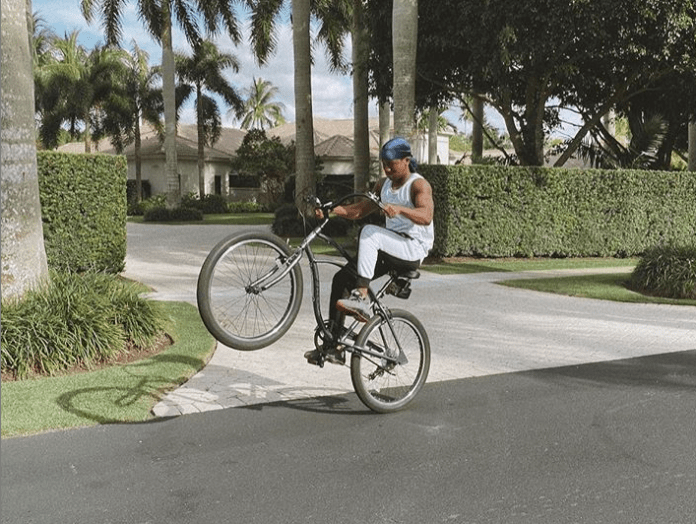 Abraham Attah riding his bicycle skillfully