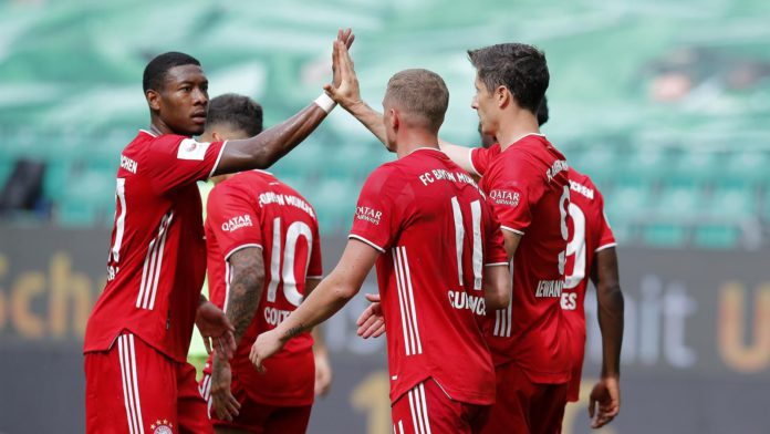 Robert Lewandowski of Bayern Muenchen celebrates the third goal for his team with Michael Cuisance of Bayern Muenchen and David Alaba of Bayern Muenchen during the Bundesliga match between VfL Wolfsburg and FC Bayern Muenchen at Volkswagen Arena on June 2 Image credit: Getty Images