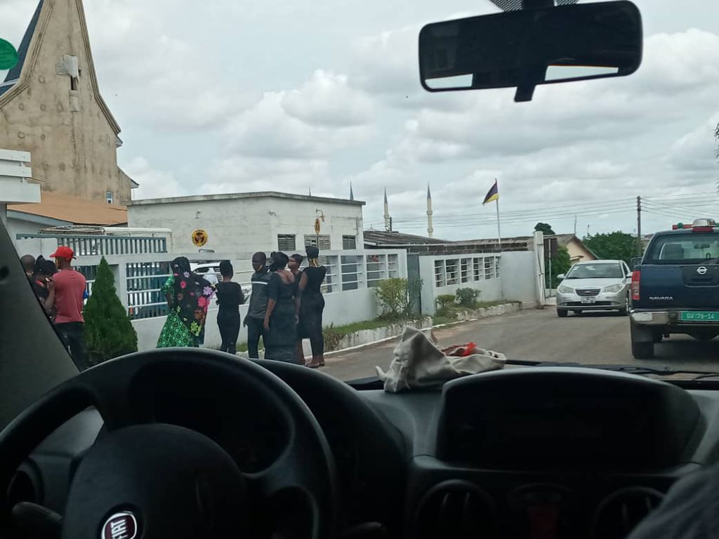 Some relatives of the dead at the 37 Military hospital look on as AMA officials prepare to transport their dead for burial